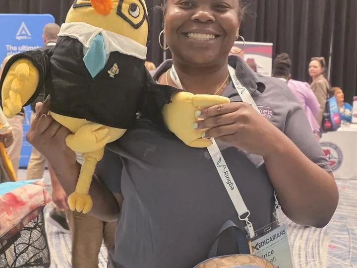 An agent with the AgentMethods mascot at a conference